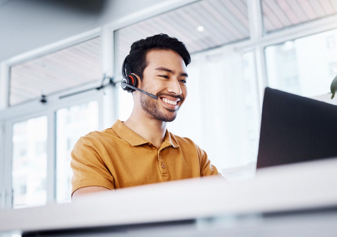 Person with customer support headset on answering online program management questions